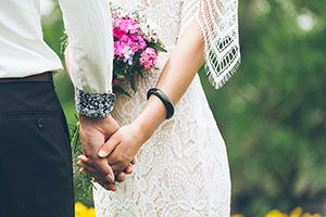 Newlywed couple, holding hands